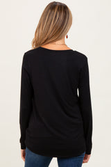 woman wearing a black long sleeve maternity top, showing the back view with a relaxed fit