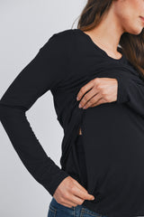 woman wearing a black long sleeve maternity top with a side opening for nursing access