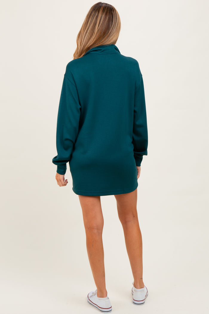 woman wearing a dark teal long sleeve maternity sweatshirt dress, view from the back