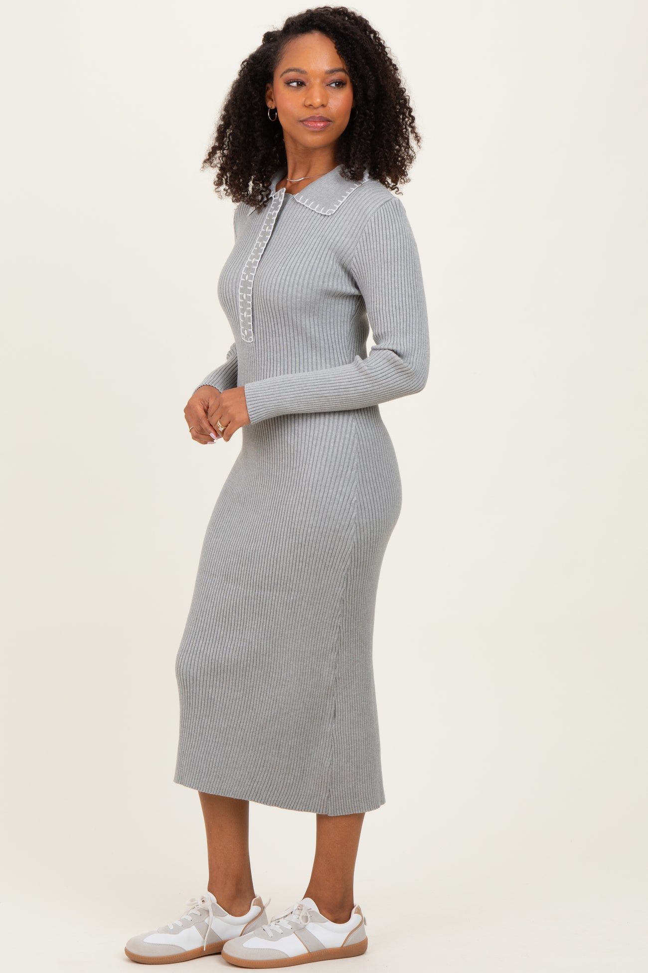 woman wearing a gray ribbed knit midi dress with a collar and long sleeves