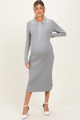 woman wearing a gray ribbed maternity dress with a collared neckline and buttons, showcasing her baby bump