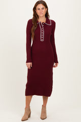 woman wearing a burgundy ribbed midi dress with a collar and button details
