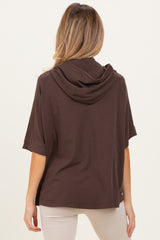 woman wearing a brown short sleeve maternity hoodie with a relaxed fit, viewed from the back