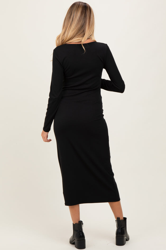 woman wearing a black long sleeve maternity dress, showing a fitted silhouette from the back