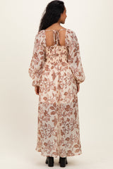 woman wearing a floral printed maternity maxi dress with a smocked back and long sleeves