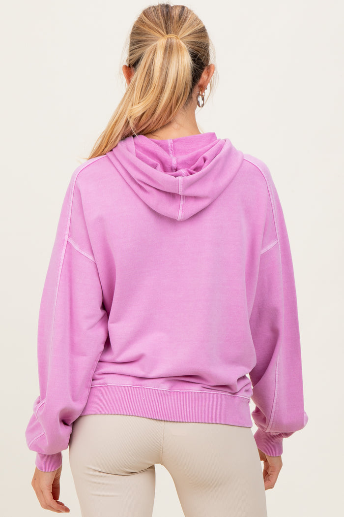 woman wearing a purple oversized maternity hoodie with a hood and balloon sleeves, viewed from the back