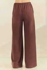 wide leg brown trousers with an elastic waistband and side pockets