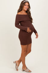 woman wearing a brown off-the-shoulder maternity sweater dress and holding her baby bump
