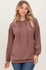 woman wearing a ribbed mauve hoodie with a drawstring and relaxed fit, styled with blue jeans