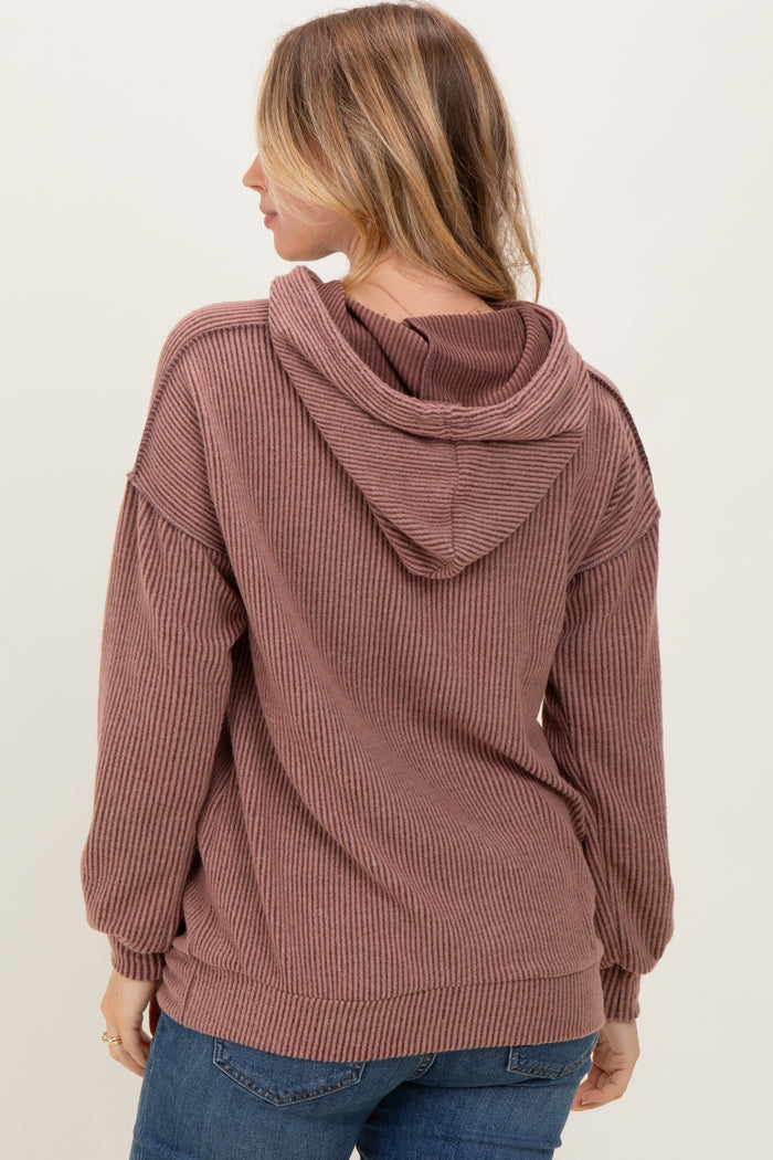 woman wearing a mauve ribbed hoodie with a back hood and dropped shoulders, styled with blue jeans