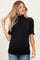 woman wearing a black ribbed maternity top with short sleeves and a fitted silhouette, showing her baby bump