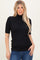 woman wearing a black short sleeve ribbed turtleneck top with a fitted silhouette