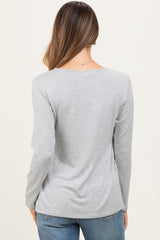 woman wearing a gray long sleeve maternity top viewed from the back