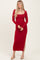 woman wearing a long sleeve red fitted maxi dress with a square neckline and side slit