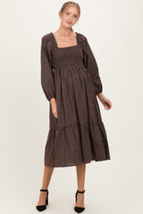 woman wearing a brown checkered maternity dress with a square neckline and balloon sleeves