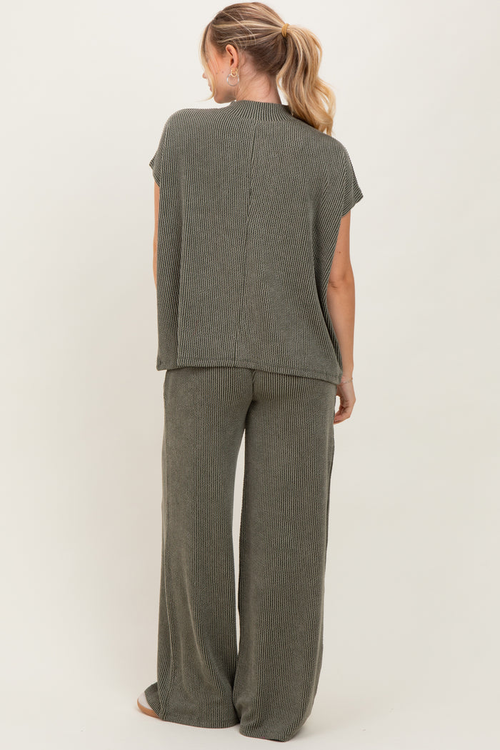 woman wearing a sage green striped two-piece lounge set with short sleeves and wide-leg pants