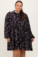 woman wearing a black floral plus size dress with long sleeves and a tiered skirt