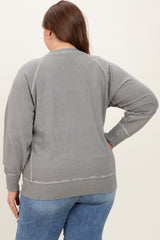 woman wearing a gray maternity plus sweatshirt with a relaxed fit, showing the back view and styled with jeans