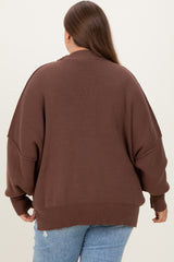 woman wearing a brown oversized maternity sweater with dropped shoulders and ribbed detailing, back view