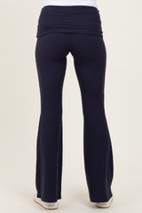 woman wearing navy blue maternity yoga pants with a flattering wide waistband, shown from the back