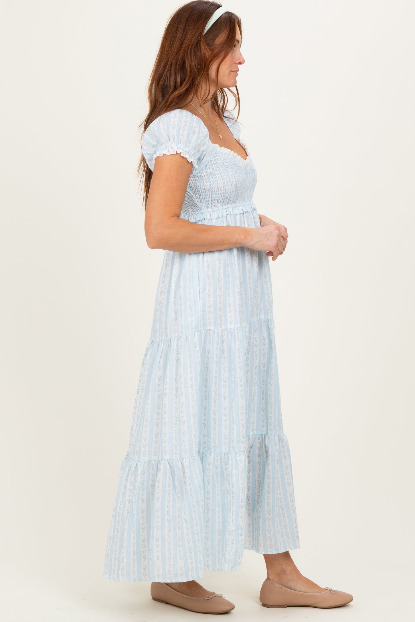 woman wearing a light blue tiered maxi dress with puff sleeves and a smocked bodice