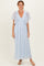 woman wearing a light blue floral maxi dress with flutter sleeves and button details