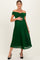 woman wearing a dark green pleated off-shoulder maternity dress with a visible baby bump