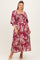 woman wearing a burgundy floral maternity dress with a square neckline and bell sleeves, showcasing a baby bump