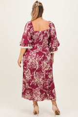 woman wearing a burgundy floral print maternity dress with puffed sleeves and a square neckline, showing a baby bump