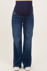 woman wearing a pair of dark wash maternity flared jeans with a high waistband