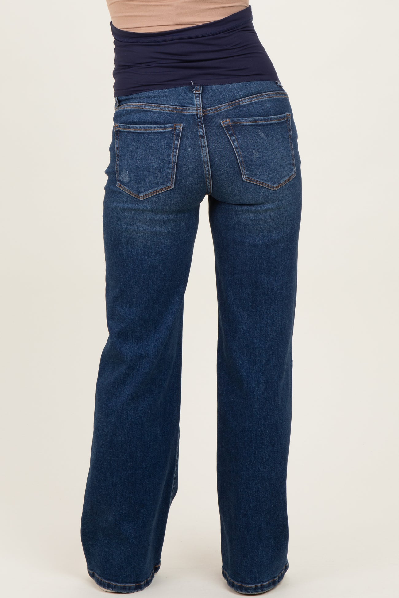 woman wearing dark blue maternity jeans viewed from the back