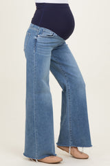 maternity wear blue flare jeans with a high waist and stretchy panel for a baby bump, model showing side view