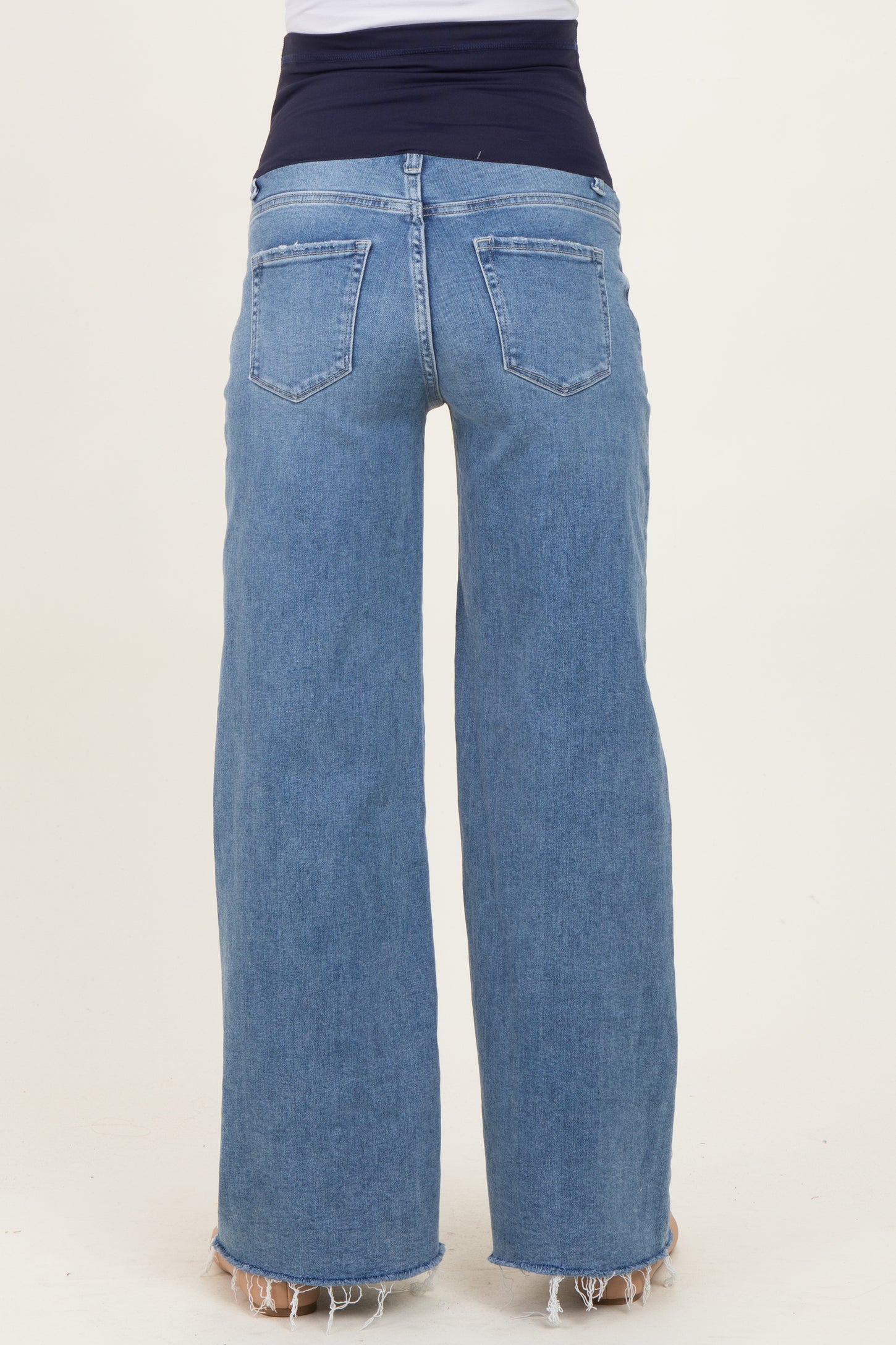 woman wearing light blue maternity wide-leg jeans with a stretchy black waistband, seen from the back