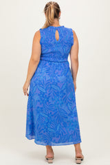 woman wearing a blue floral print maternity plus dress with a keyhole back and ruffled sleeves