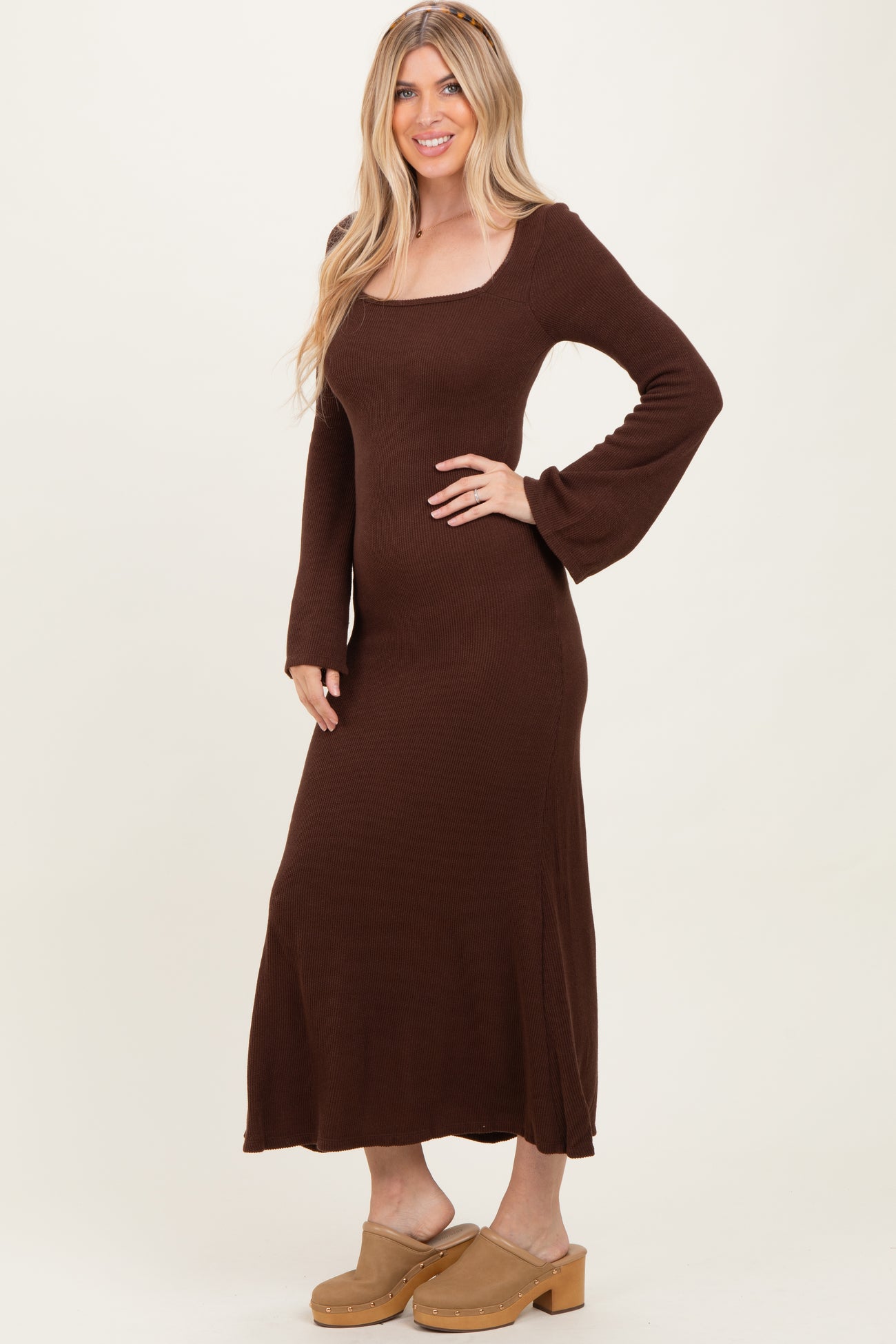 woman wearing a brown long sleeve ribbed maxi dress and beige platform clogs