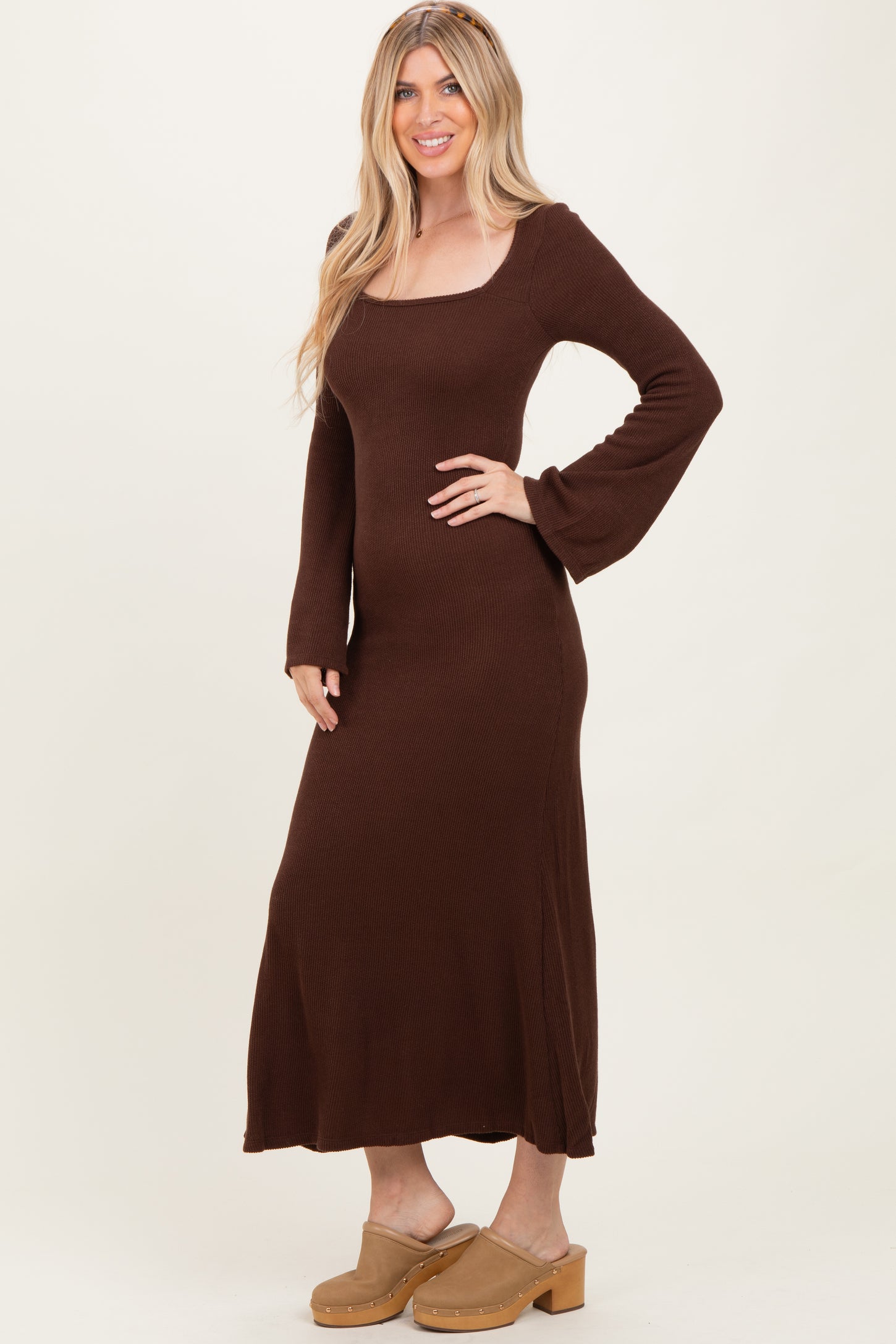 woman wearing a brown long sleeve ribbed maxi dress and beige platform clogs