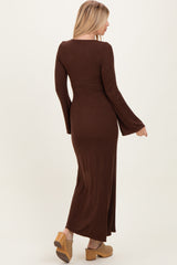 woman wearing a brown ribbed long sleeve maxi dress with flared sleeves, shown from the back