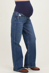 woman wearing a pair of dark blue maternity jeans with a smooth underbelly support band and flared leg style