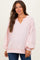 woman wearing a light pink maternity pullover with a v-neck and balloon sleeves