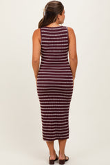 woman wearing a maroon and white striped maternity dress, fitted style, showing a side view of her baby bump