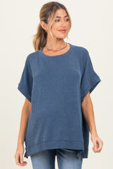 woman wearing a navy blue ribbed maternity top with short sleeves and a relaxed fit