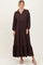 woman wearing a dark brown long sleeve maxi dress with a button-down collar and tiered hem