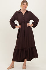 woman wearing a chocolate brown long sleeve maxi dress with a button-up collar and tiered skirt