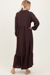 woman wearing a long brown tiered maxi dress with a collared neck and long sleeves, viewed from the back
