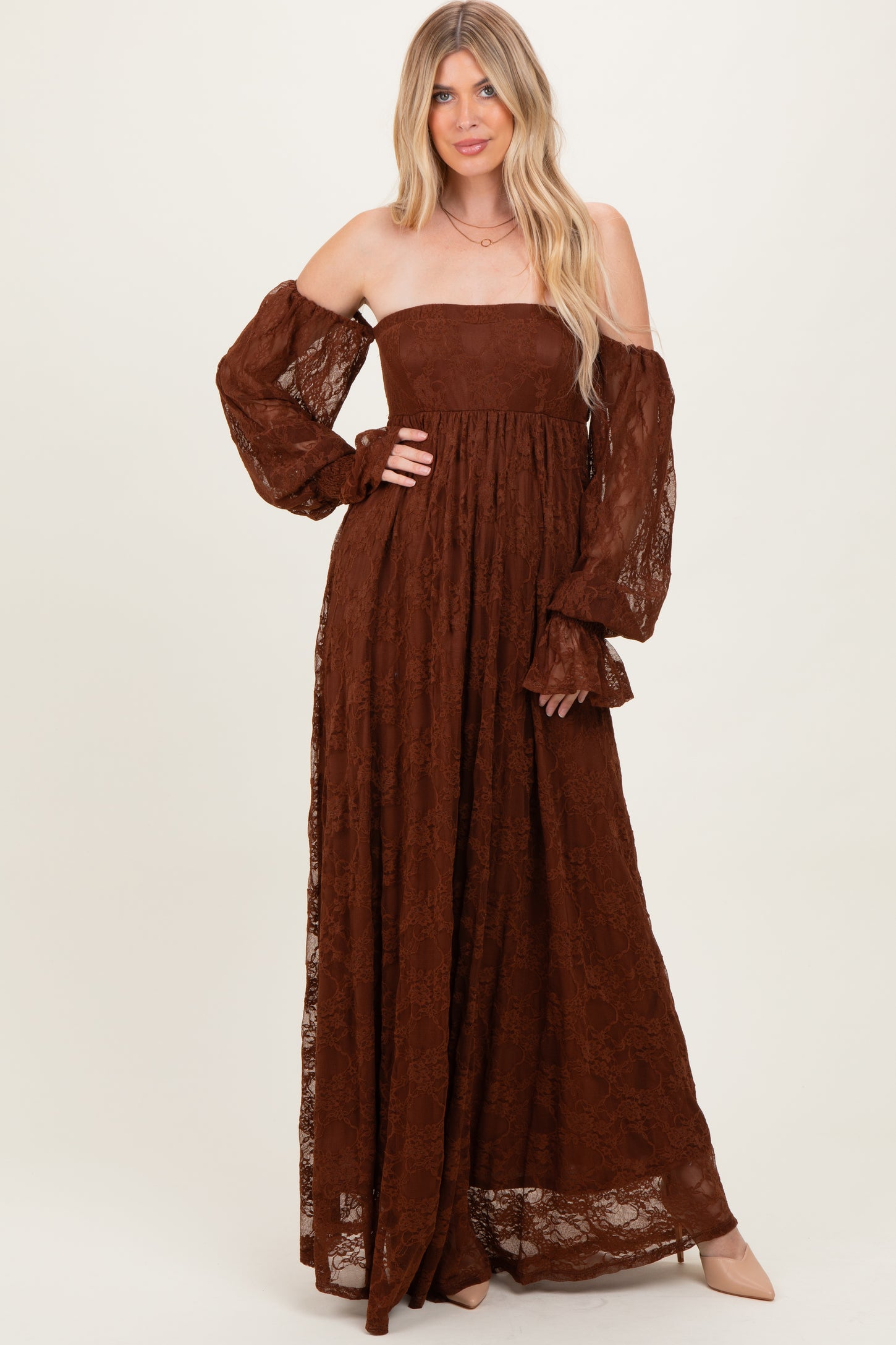 woman wearing a brown lace off-shoulder maxi dress with long puff sleeves