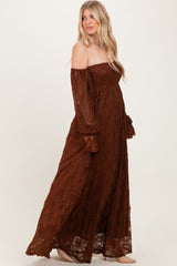 woman wearing a brown off-the-shoulder lace maxi dress with long bell sleeves