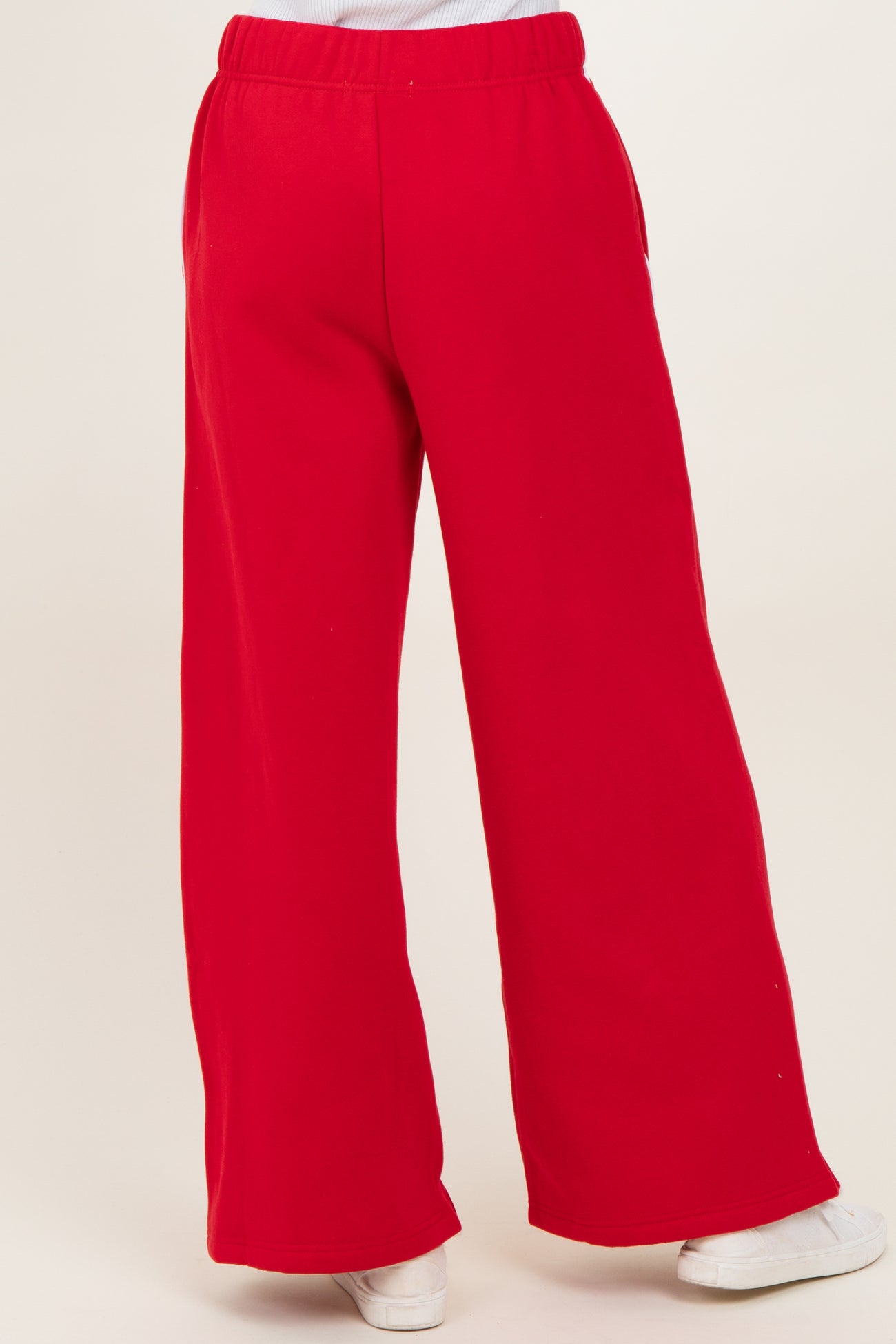 woman wearing red wide-leg sweatpants with an elastic waistband and side pockets