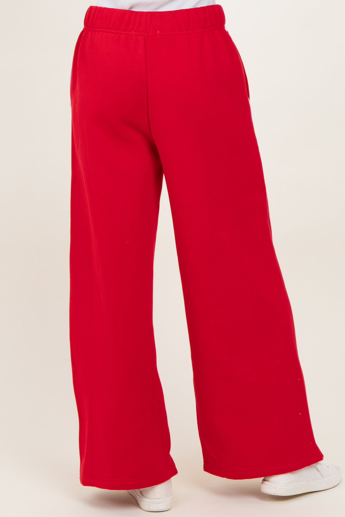 woman wearing red wide-leg sweatpants with an elastic waistband and side pockets