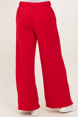 woman wearing red wide-leg sweatpants with an elastic waistband and side pockets