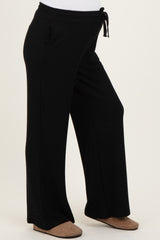 maternity wear black wide leg lounge pants with a drawstring waist and side pockets, featuring a visible baby bump